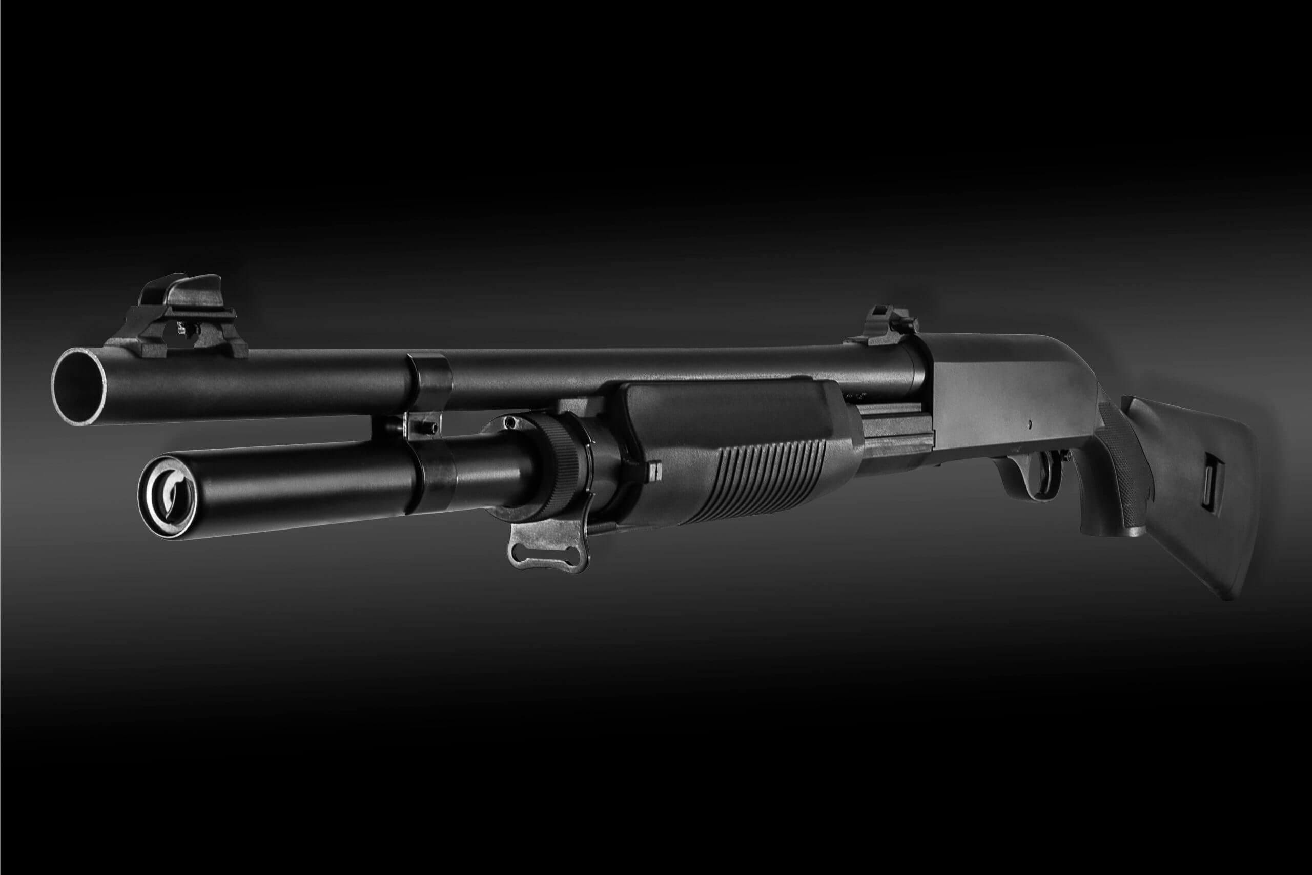 Pump action shotgun on black background